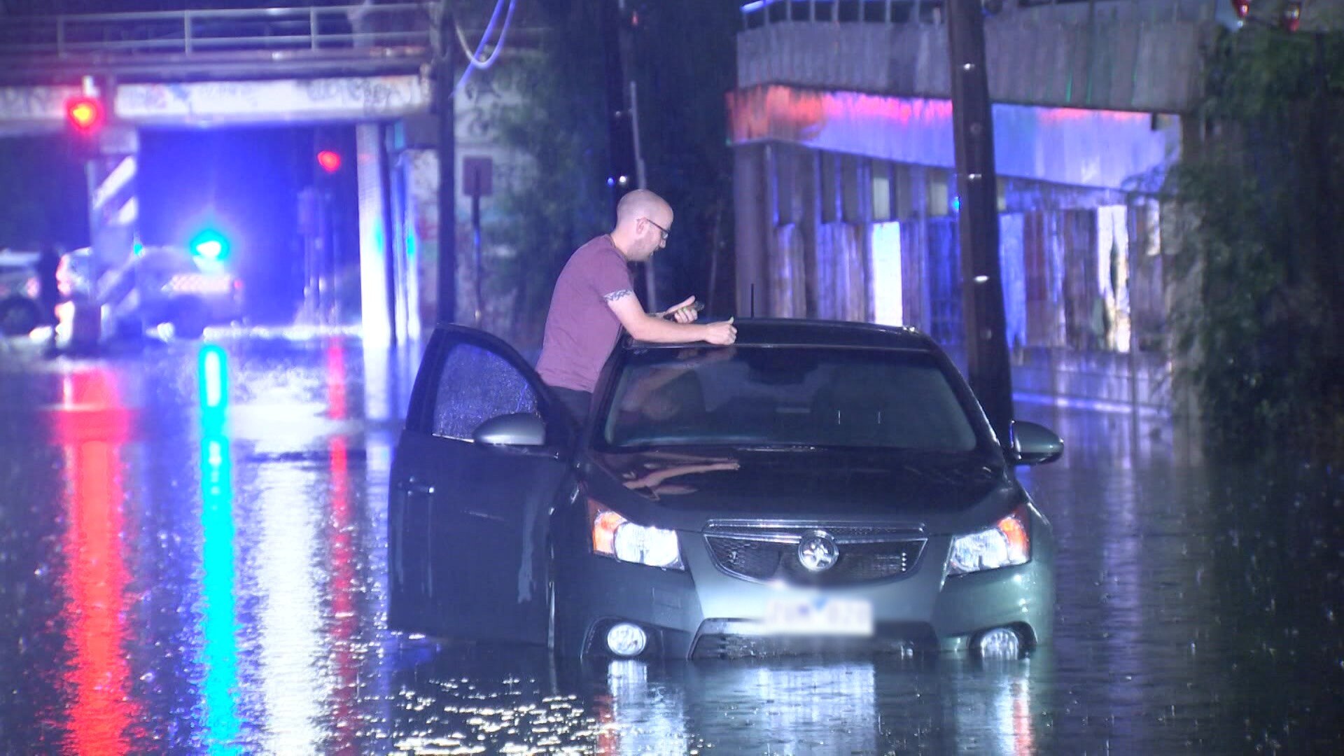 Lucky escape for woman swept into stormwater drain as heavy rain sweeps ...