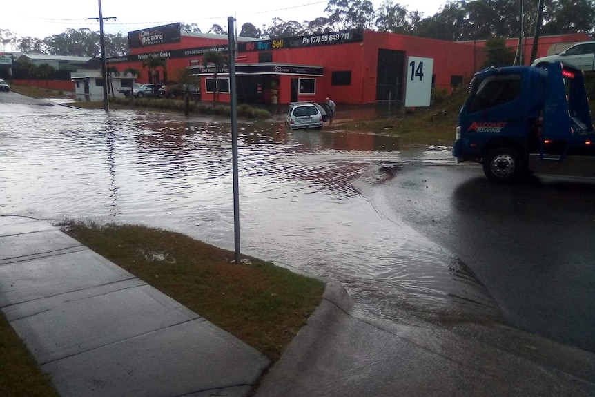 Floodwaters over the road at Molendinar.