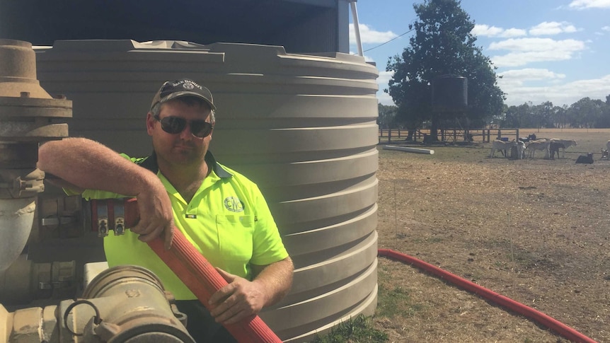 Casterton water carrier Clinton Beever pumps domestic water into a farming family's tank.