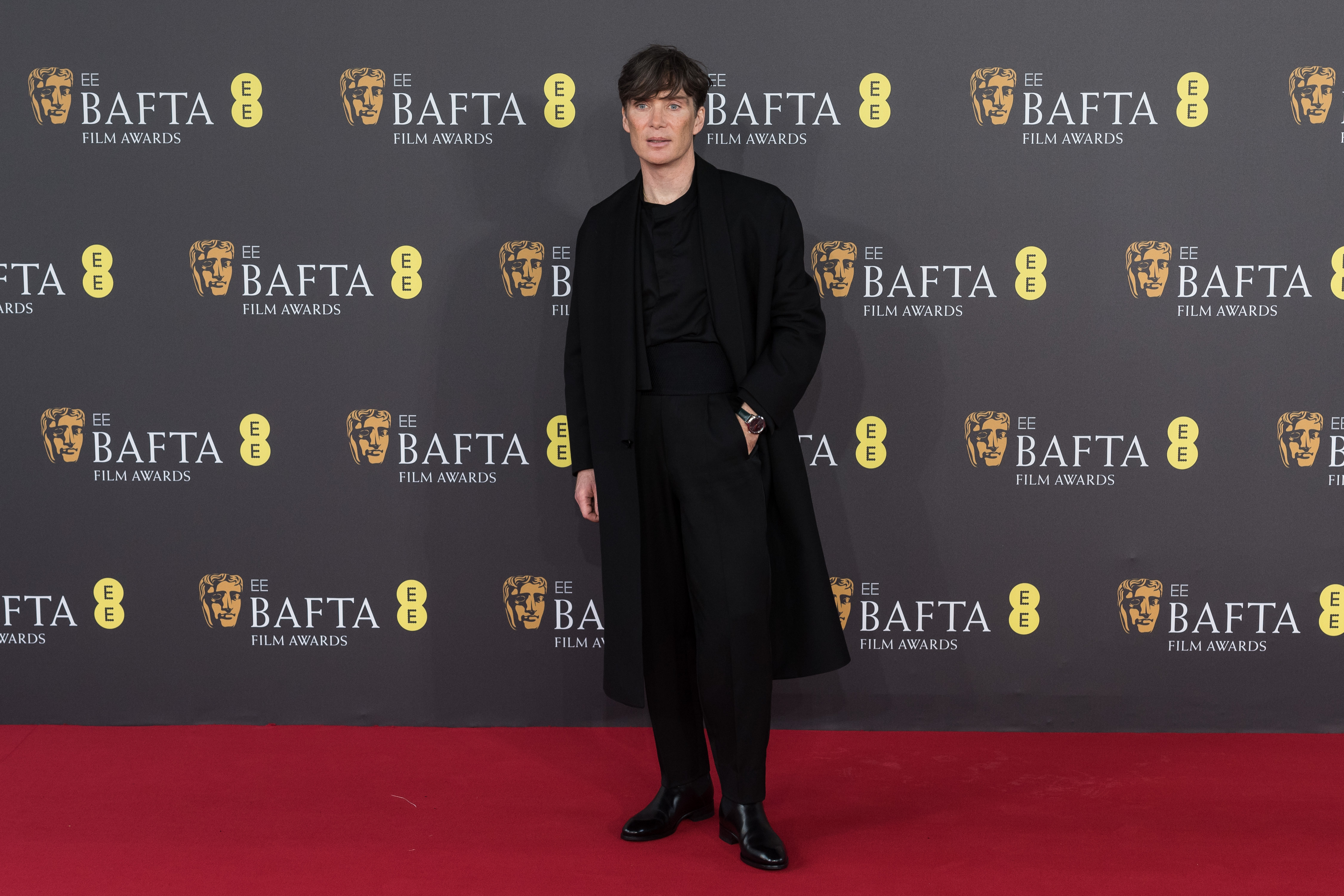 Actor Cillian Murphy on the red carpet wearing a black suit and coat