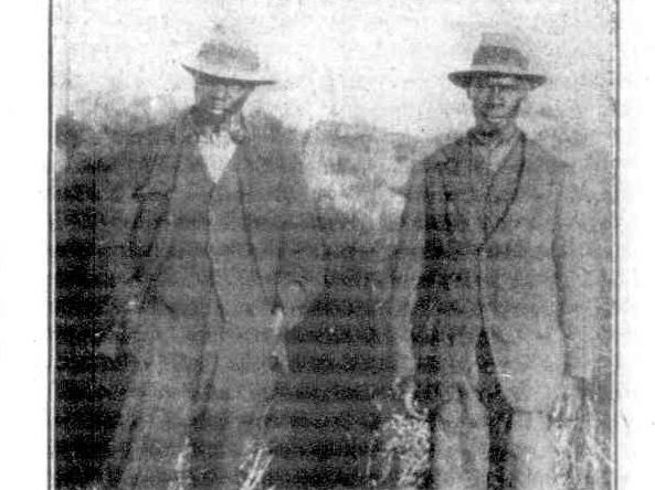 A black and white newspaper photo of two Aboriginal men in suits, who found the murdered men.