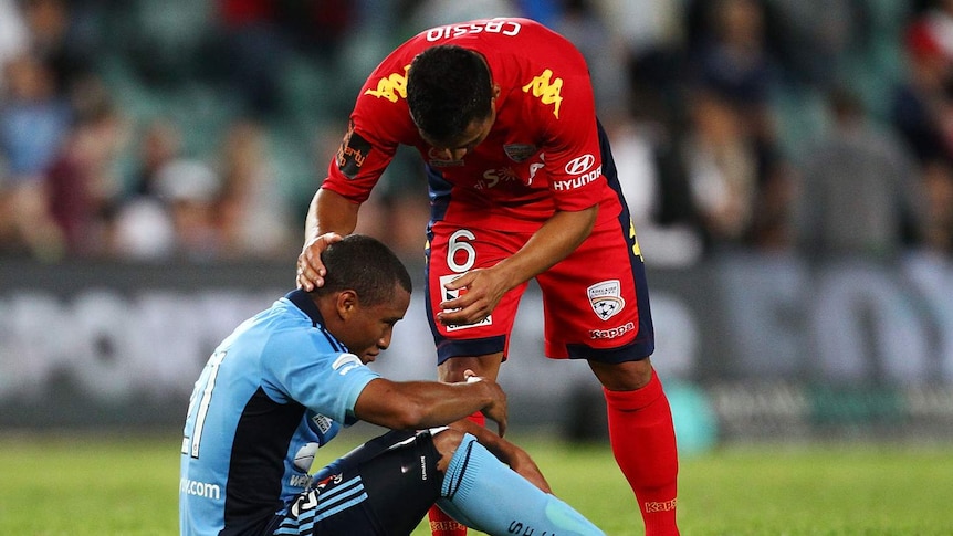 Adelaide's Cassio consoles Sydney FC goalscorer Yairo Yau at the Sydney Football Stadium.