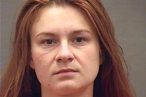 Mug shot of Maria Butina wearing an orange prison jumpsuit, looking directly at the camera