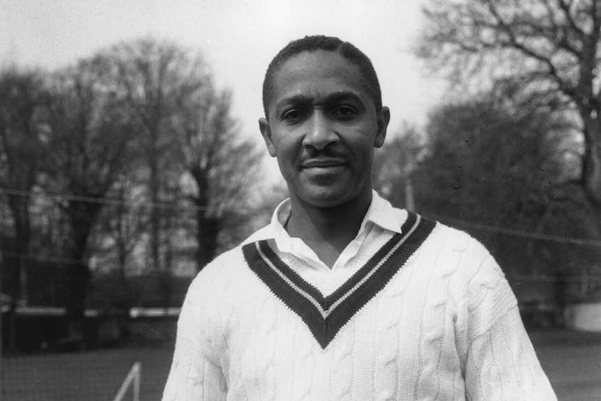Frank Worrell wears a cricket jumper and looks towards the camera