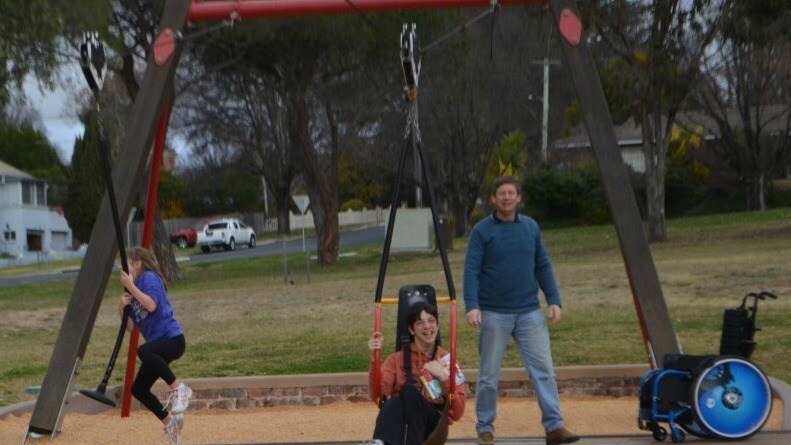 Braedon Jones on a flying fox designed for someone with a disability alongside his sister on a traditional flying fox.