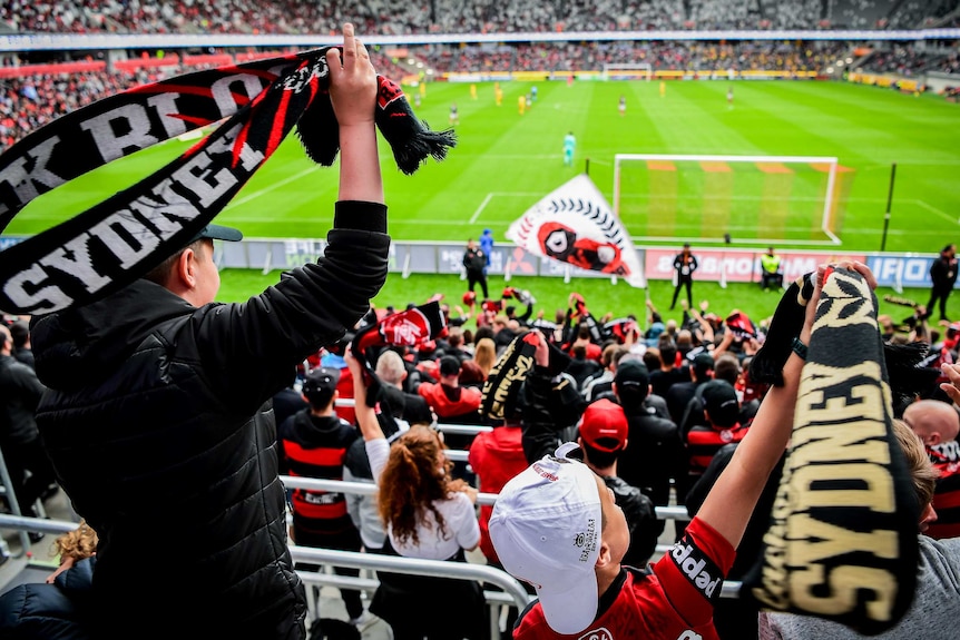 Scarves are in shot, but the field can be seen in the background.