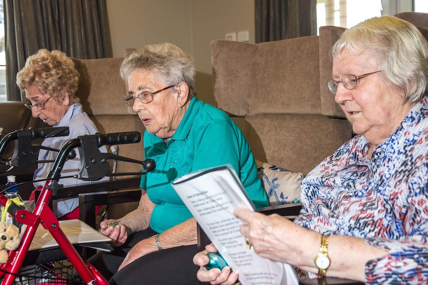Good generic: aged care residents sitting in arm chairs with walking frames