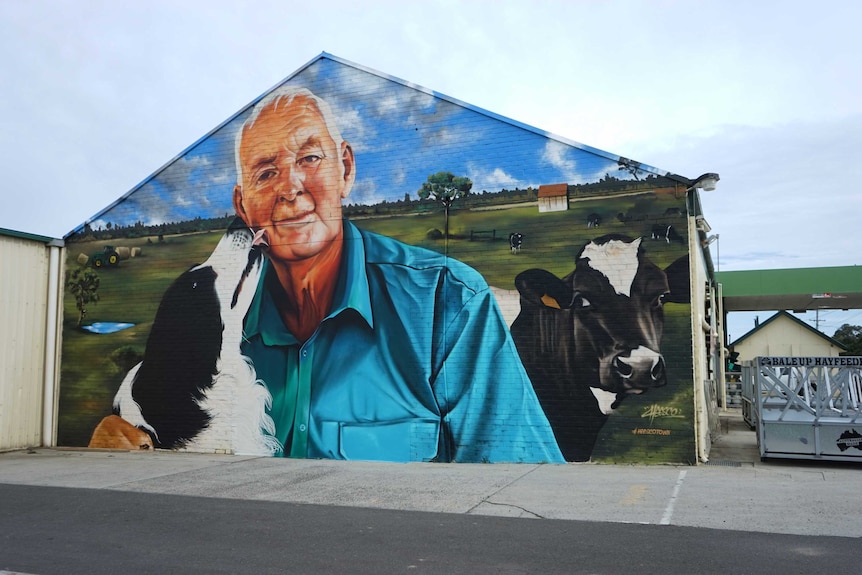 A mural showing a collie licking an older man's face.