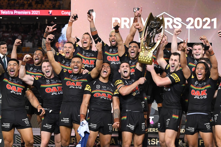 Rugby league grand final winner celebrate with the trophy