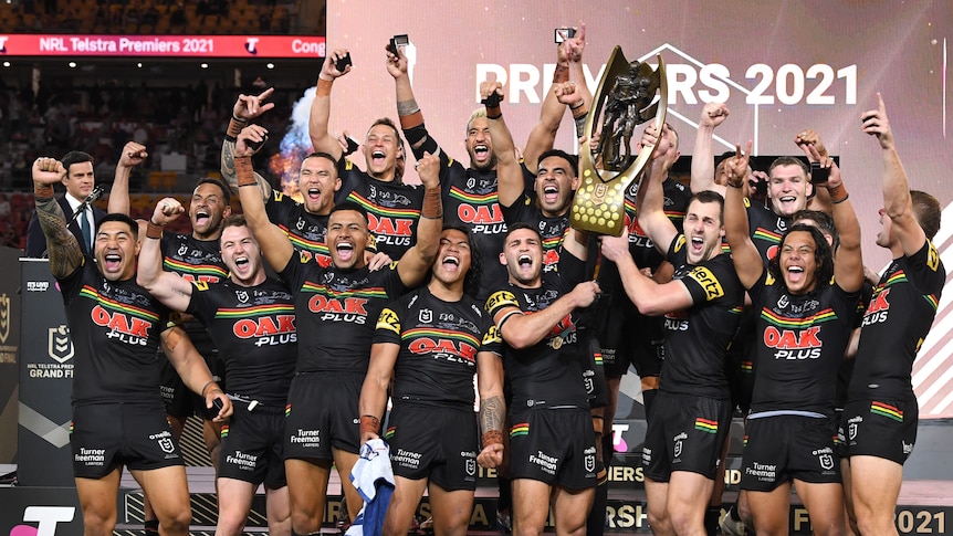 Rugby league grand final winner celebrate with the trophy