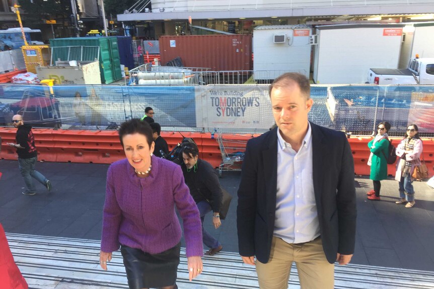 Clover Moore and Mick Fuller walking up steps.