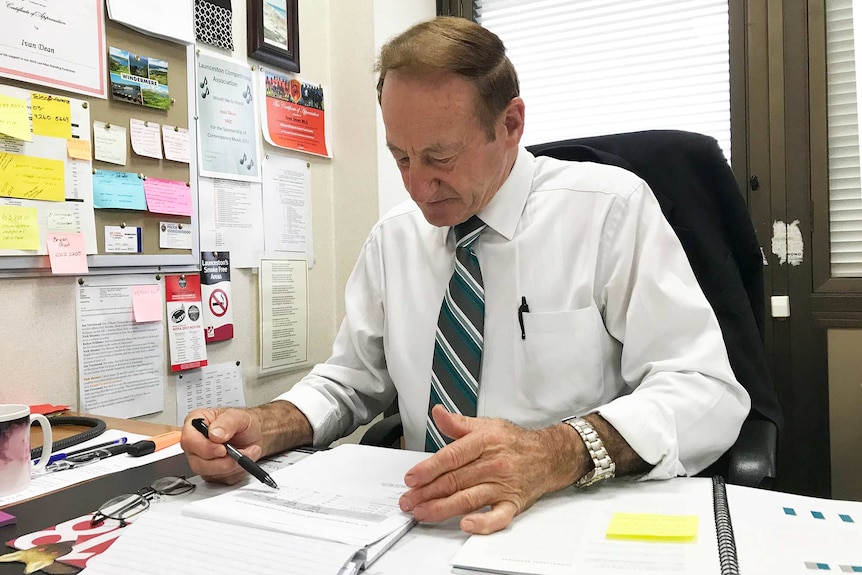 Ivan Dean working at his office desk.