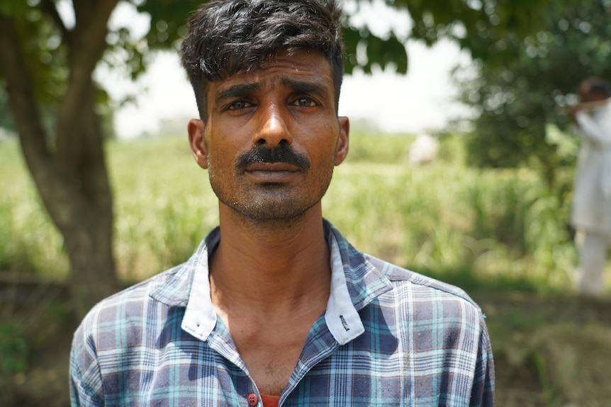 An Indian man with a moustache looking mournful 