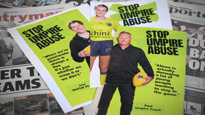 Three green flyers for 'stop umpire abuse' lay over a collection of newspapers