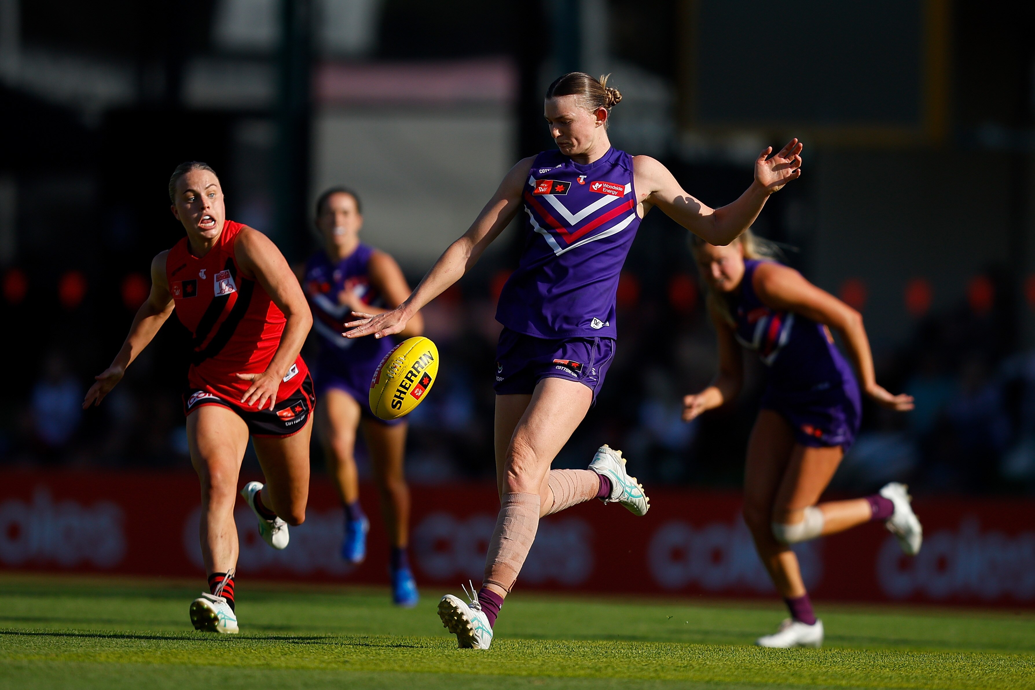 Mim Strom kicks the ball for the Dockers against Essendon in their elimination AFLW final