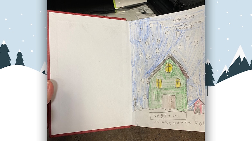 An open book shows the first page of an illustated story made by a child, with a green house shown as snow falls.
