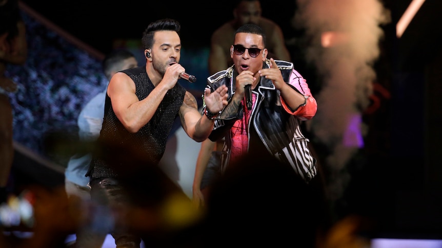 Singers Luis Fonsi and Daddy Yankee perform and dance on stage during Latin Billboard Awards.