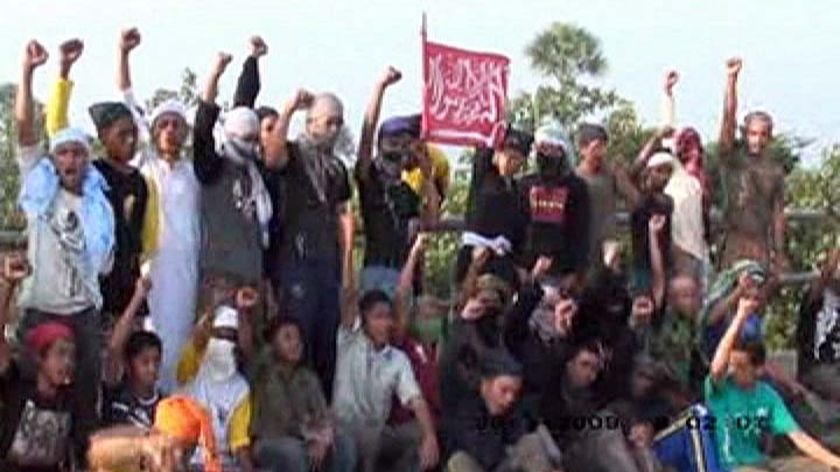 Members of a new terrorist cell in Aceh, north Sumatra, raise their fists