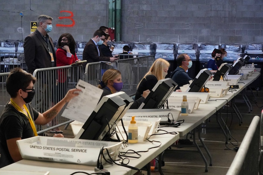 A row of election workers process ballots in Pittsburgh.