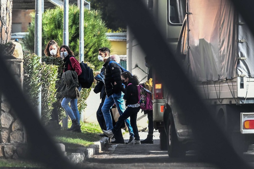 Italian citizens arrive at a quarantine center