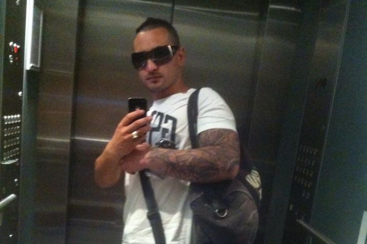 A man taking a selfie in an elevator mirror