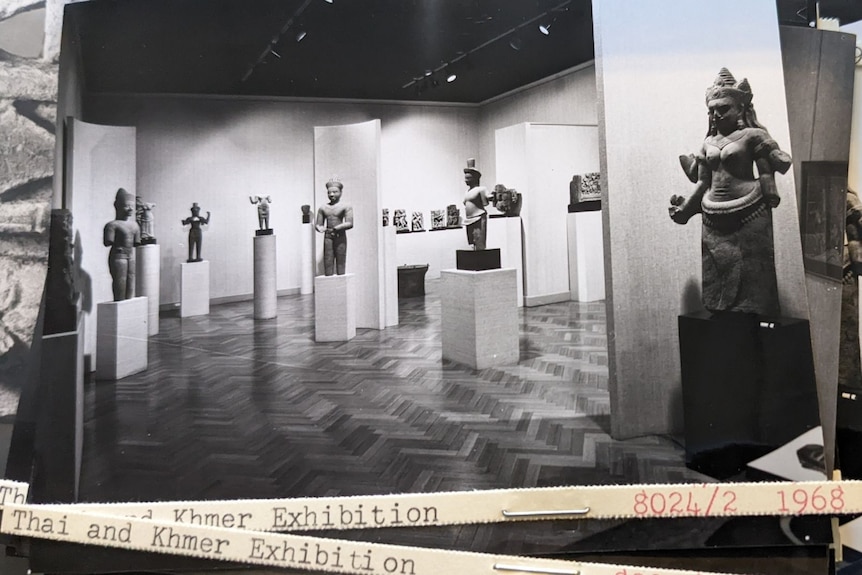 Black and white image of an exhibition showing ancient sculptures