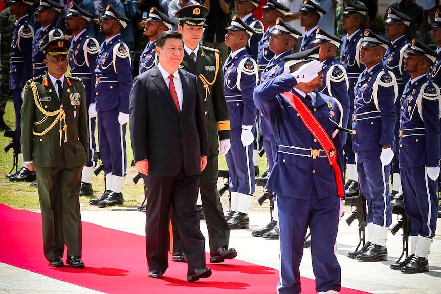 Xi Jinping walks past a military honour guard