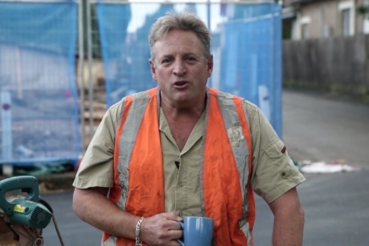 A man dressed as a tradesman in high vis for a Liberal Party campaign advertisement