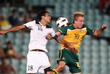 Mitch Nichols playing for Olyroos going up for a header against Uzbekistan