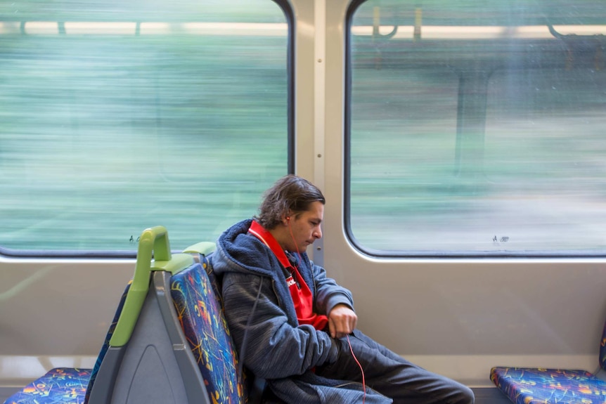 TJ Carpenter sits on a train.