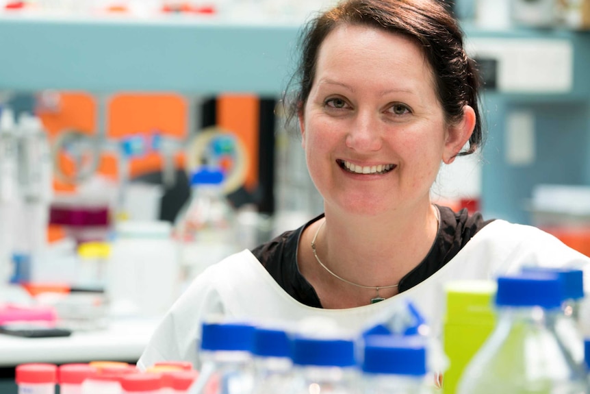 Griffith University Associate Professor Kate Seib surrounded by equipment in a science laboratory