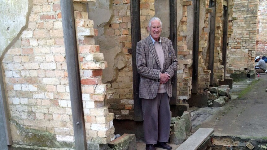 Alex McLaren stands next to a Port Arthur archaeological dig which uncovered parts of a mill.