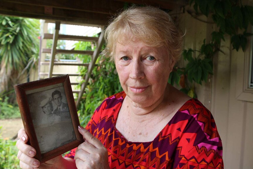 Margaret Kloostra holds a photo of her parents on their wedding day at her house at Goodna.