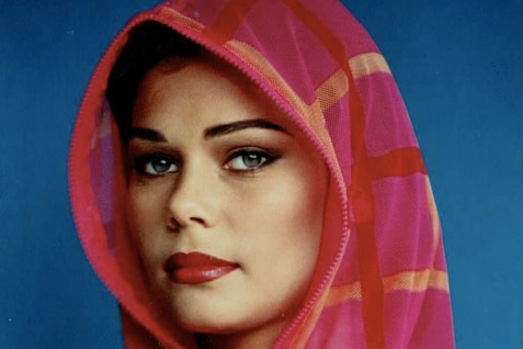 A young woman in a pink hooded jumped with red lipstick