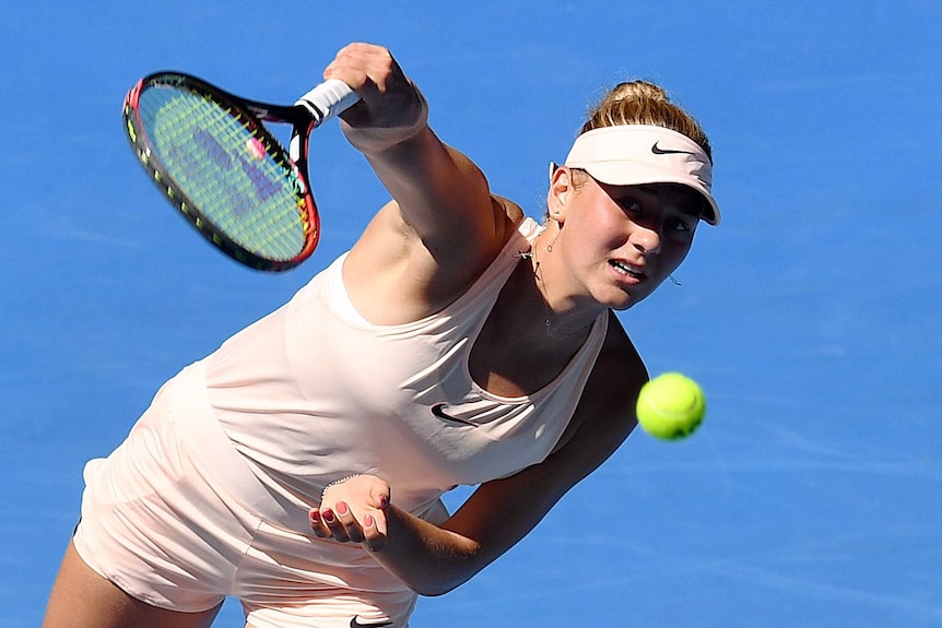 Marta Kostyuk serves at Australian Open