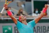 Rafael Nadal raises his arms in triumph as a celebration.