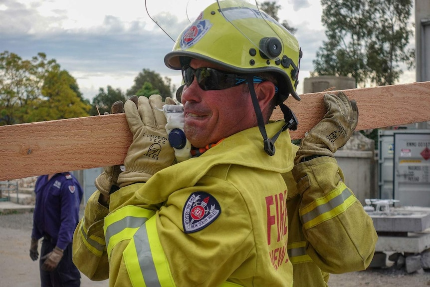 A man holding a piece of wood.