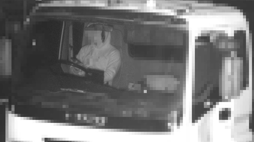Truck driver using mobile phone and bot wearing seatbelt