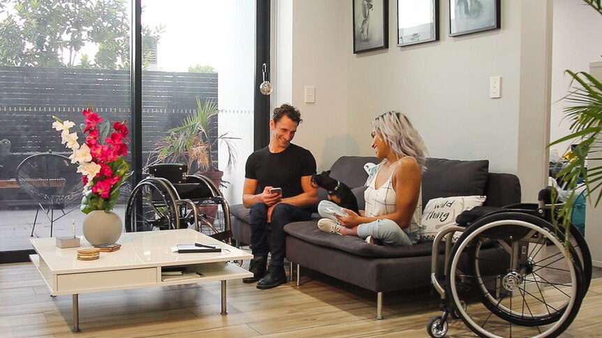 Madison de Rozario and Josh George at home with their pet dog.