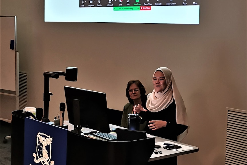 A woman gives a presentation at a university
