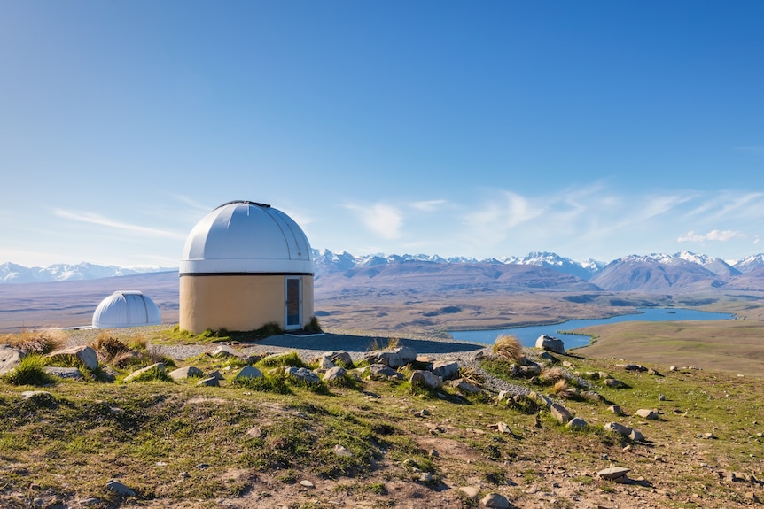 A dome atop a mountain and a lake below