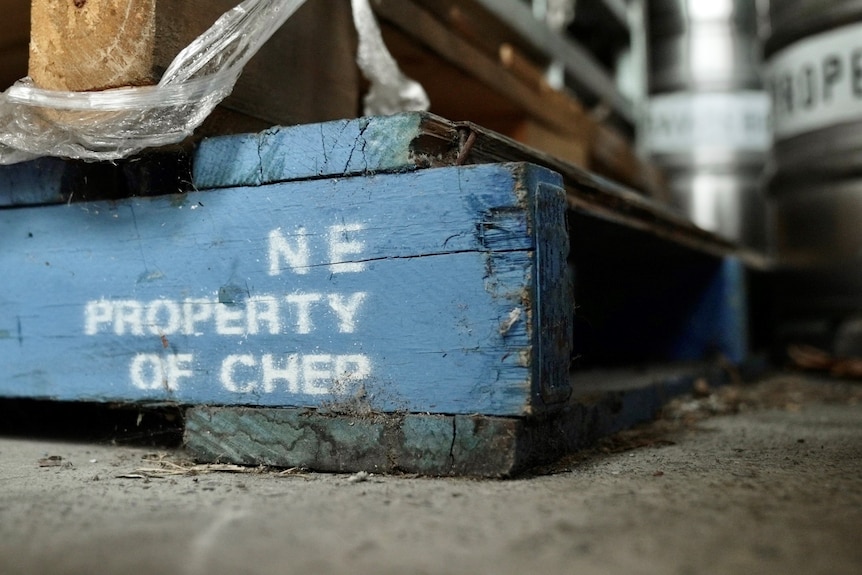 A CHEP pallet sitting on the ground, with a label saying "property of CHEP".