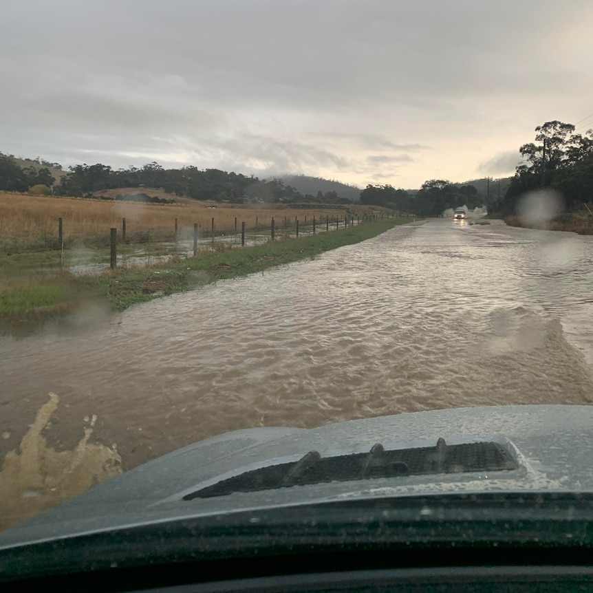 A car enters a flooded road.