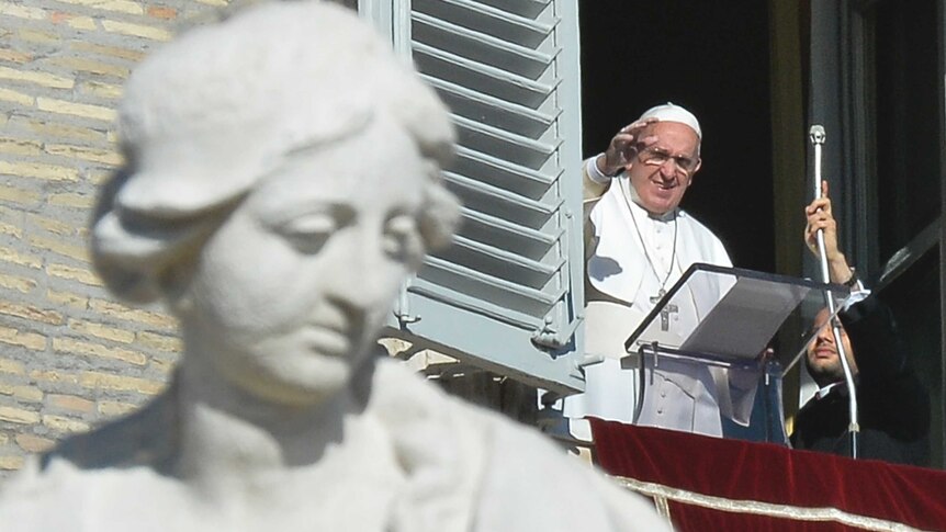 Pope Francis greets the crowd from the window of the Apostolic Palace during his Angelus prayer on January 1, 2015