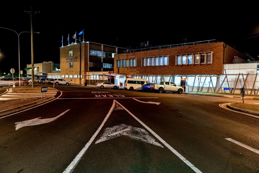 A night scene of a hospital exterior.