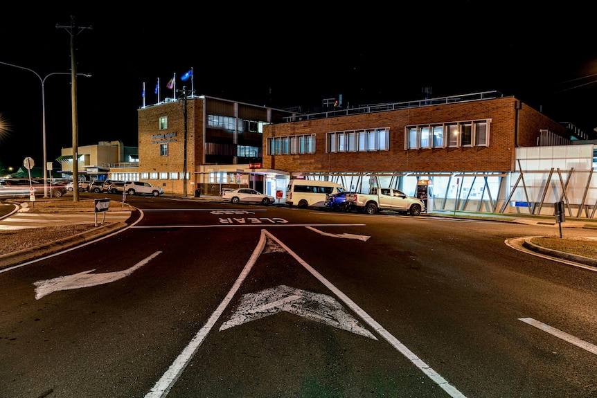 A night scene of a hospital exterior.