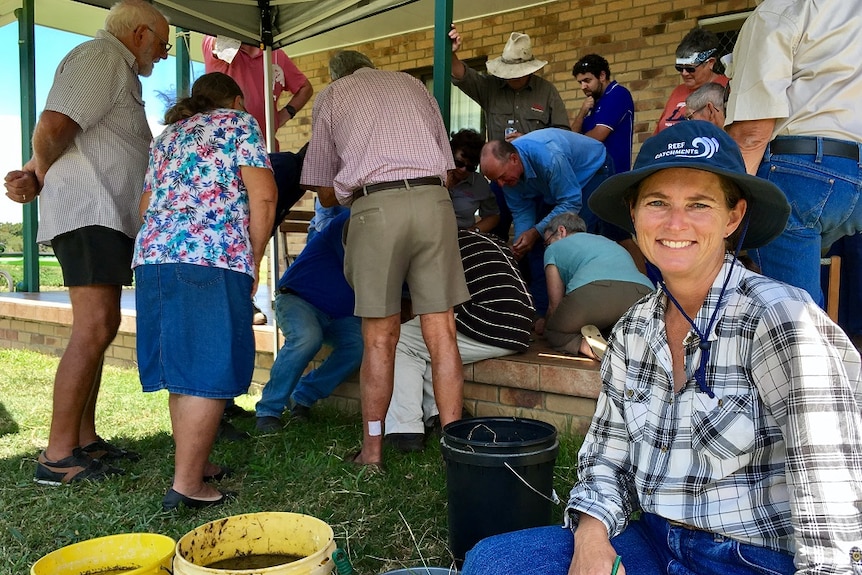 Mackay cattle producer Roxanne Morgan sits in front of a crowd.