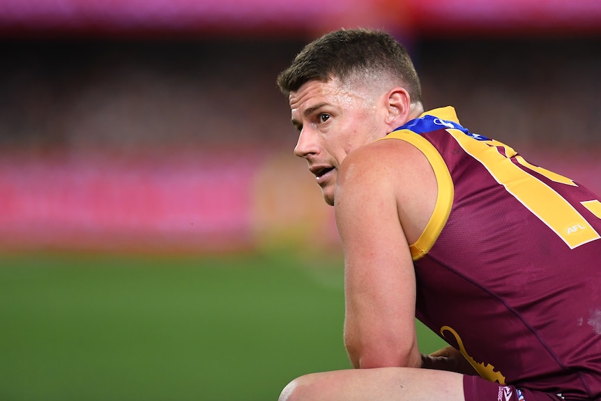 Dayne Zorko looks over his shoulder while on his haunches