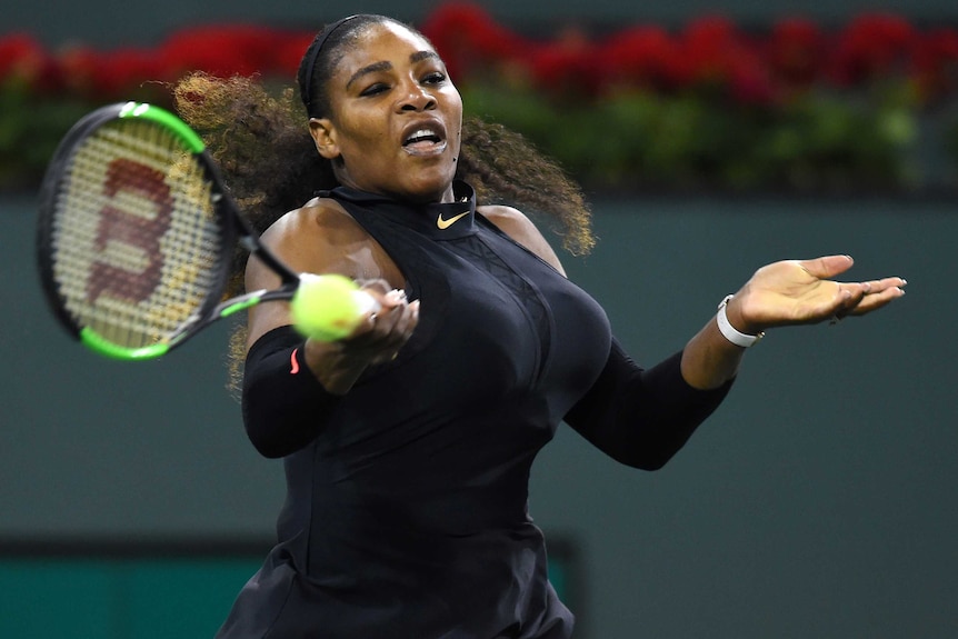 Serena Williams plays a forehand during her first-round match against Zarina Diyas.