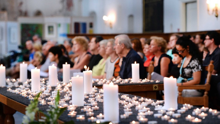 People attend a church service in memory of MH17 victims